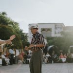 Elderly couple dancing in sunlit León de los Aldama plaza, showcasing joy and community spirit.