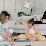 A family enjoying leisure and remote work together in a cozy home setting.