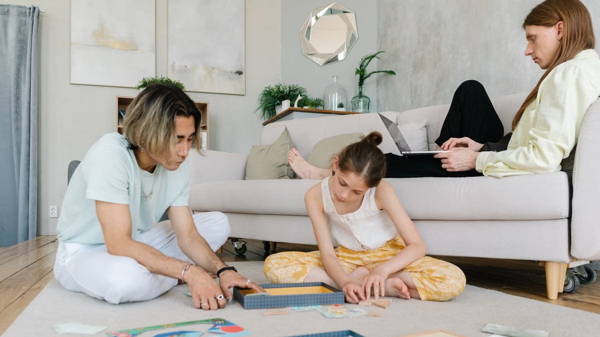 A family enjoying leisure and remote work together in a cozy home setting.